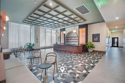 a lobby with tables and chairs in a building at Sophisticated Studio with Pools in Miami