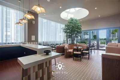 a lobby with a restaurant with tables and chairs at Sophisticated Studio with Pools in Miami