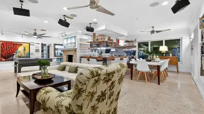 a living room with a couch and a table at Casa Pineapple Social by AvantStay Spa Game Room EV Charger Near Las Olas Fort Lauderdale Beaches Sleeps 16 in Fort Lauderdale