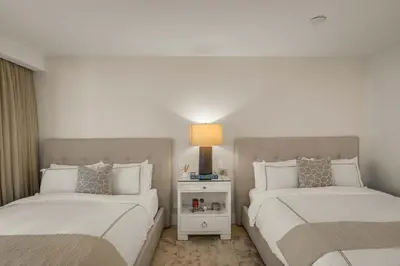 a bedroom with two beds and a lamp in it at Seaside Condo - Studio for 4 in Miami Beach