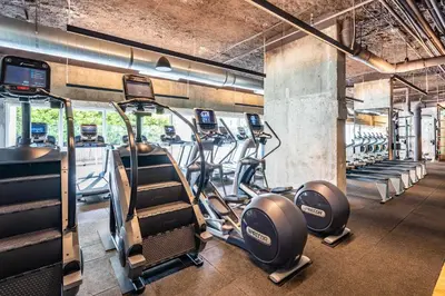 a gym with several treadmills and cardio machines at Seaside Condo - Studio for 4 in Miami Beach