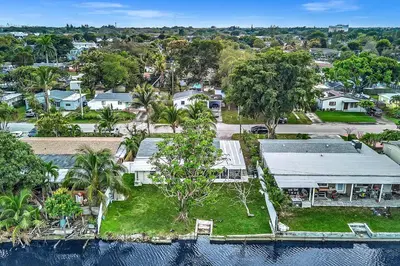 an overhead view of a house with trees and water at Waterfront Modern Hollywood Hard Rock airport in Fort Lauderdale