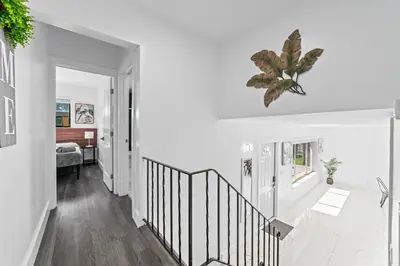 a white hallway with a staircase and a bedroom at Casa Sol - 4 Bedroom 2 Bath - 7 beds - Affordable Stays For Large Groups in Ives Estates