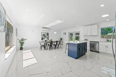 a kitchen and dining room with white walls and marble floors at Casa Sol - 4 Bedroom 2 Bath - 7 beds - Affordable Stays For Large Groups in Ives Estates