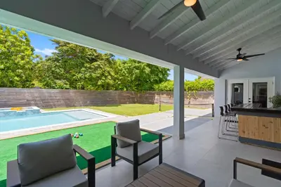 a patio with a pool and a table and chairs at Heated Pool Games Family Haven Near FIU