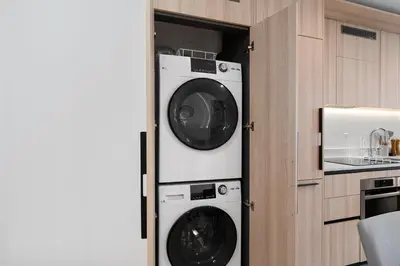 a kitchen with two washer and dryer in a cabinet at Upscale Residence at District 225 - Downtown Miami in Miami