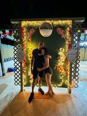 a man holding a child in front of a christmas display at Kayoma Hostel in Miami