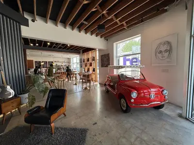 a room with an old red car parked in it at Kayoma Hostel in Miami
