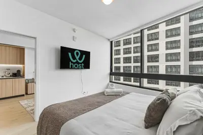 a bedroom with a bed and a large window at Hotel-Style Condo at District 225 in Downtown Miami in Miami