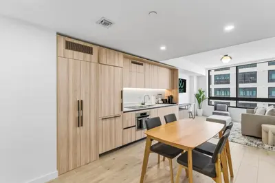 a kitchen and dining room with a table and chairs at Hotel-Style Condo at District 225 in Downtown Miami in Miami