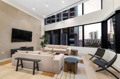 a living room with a couch and a tv at Hotel-Style Condo at District 225 in Downtown Miami in Miami