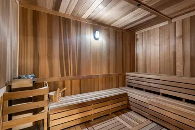 a sauna with wooden paneling and a wooden bench at Hotel-Style Condo at District 225 in Downtown Miami in Miami
