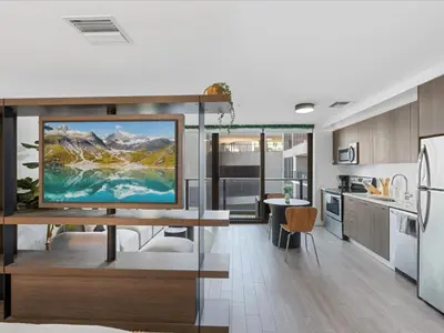 a kitchen with a large television on a table at Modern Studio by Bayside & Cruise Port in Miami