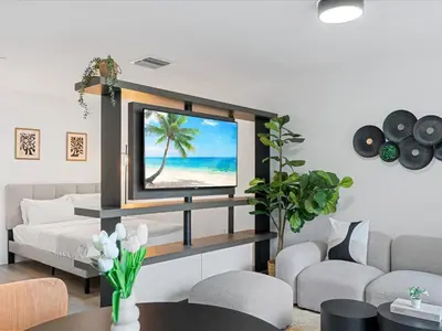 a living room with a flat screen tv on a wall at Modern Studio by Bayside & Cruise Port in Miami