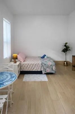 a bedroom with a bed and a table in it at Quiet Studio Retreat attached to big House in Miami