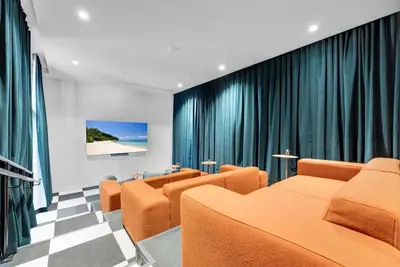 a waiting room with orange chairs and curtains at Chic Downtown Miami 2BR City Views Rooftop Pool in Miami