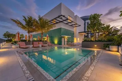 a swimming pool in front of a building at Chic Downtown Miami 2BR City Views Rooftop Pool in Miami