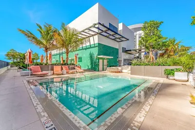 a swimming pool in front of a house at Chic Downtown Miami 2BR City Views Rooftop Pool in Miami