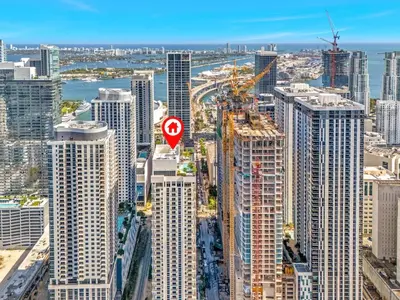 a red stop sign in the middle of a city at Chic Downtown Miami 2BR City Views Rooftop Pool in Miami