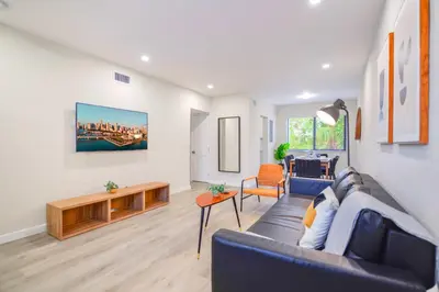 a living room with a couch and a table at Modern Apartment in Prime Miami Location in Miami