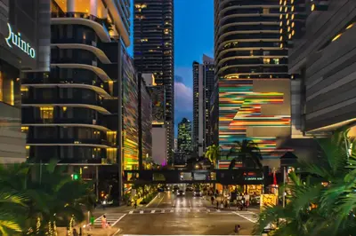 a city street at night with tall buildings at Brickell Condos by Vibras Concierge in Miami