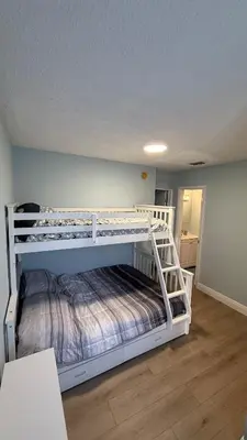 a bedroom with two bunk beds in a room at Canal-front two-bedroom condo near Sunny Isles in North Miami Beach