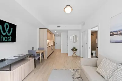 a white living room with a couch and a table at Prime Location Condo at District 225 Downtown in Miami
