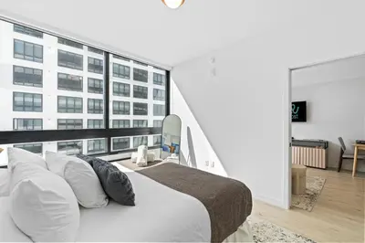 a bedroom with a large white bed and a large window at Prime Location Condo at District 225 Downtown in Miami