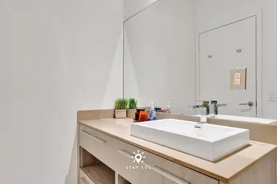 a bathroom with a white sink and a mirror at Cozy Apartment -Balcony & Beachfront Resort in Hollywood