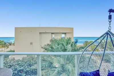 a balcony with a view of a building and the ocean at Cozy Apartment -Balcony & Beachfront Resort in Hollywood