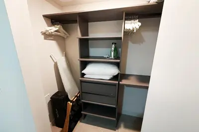 a walk in closet with black shelves and a pillow at Stylish Condo at The Crosby in Miami