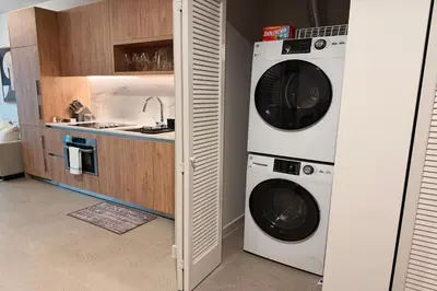 a kitchen with two washing machines and a sink at Stylish Condo at The Crosby in Miami