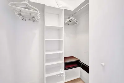 a walk in closet with white shelves at Beautiful Balcony 2BR Resort in Hollywood