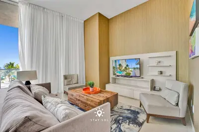 a living room with a couch and a tv at Beautiful Balcony 2BR Resort in Hollywood