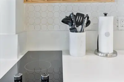 a kitchen counter with a container of kitchen utensils at Cozy Miami Beach Apartment walking distance to Beach and Ocean in Miami Beach