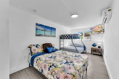 a bedroom with a bed and a chair at Cozy house with a pool in Miami in Miami