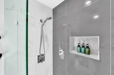 a bathroom with a shower with a glass door at Cozy house with a pool in Miami in Miami