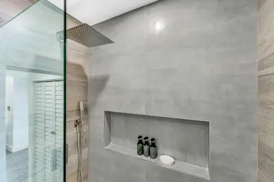 a bathroom with three bottles of wine on a wall at Cozy house with a pool in Miami in Miami