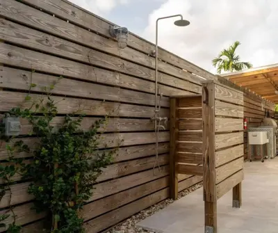 a wooden wall with a hose attached to it at Las Tortugas Modern Oasis Getaway Many Amenities in Fort Lauderdale