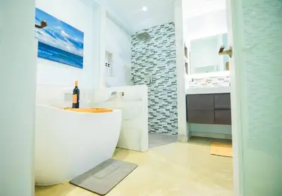 a bathroom with a white tub and a sink at Las Tortugas Modern Oasis Getaway Many Amenities in Fort Lauderdale