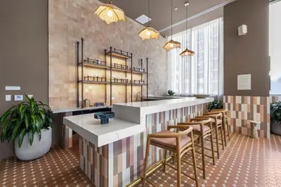 a restaurant with a bar with stools at Elegant Condo at Crosby Miami Worldcenter W Rooftop Pool & Fitness Center in Miami