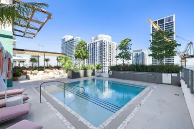 a swimming pool on top of a building with buildings at Elegant Condo at Crosby Miami Worldcenter W Rooftop Pool & Fitness Center in Miami