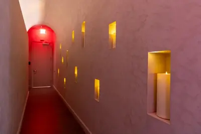 a hallway with a red door and candles on the wall at 2105 Modern studio with Balcony a Pool and a 24 hour Gym in Downtown Miami in Miami