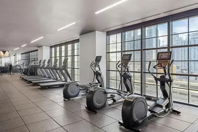 a gym with a row of treadmills and elliptical machines at 4906 Cityline Penthouse Studio with Balcony a Pool and Gym in Miami Downtown in Miami