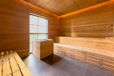 a sauna with wooden walls and a window at 4905 Corner Penthouse with Sunset Views a Pool and Gym in Downtown Miami in Miami