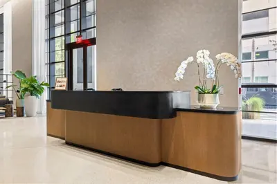 a reception desk with flowers in a lobby at 4905 Corner Penthouse with Sunset Views a Pool and Gym in Downtown Miami in Miami