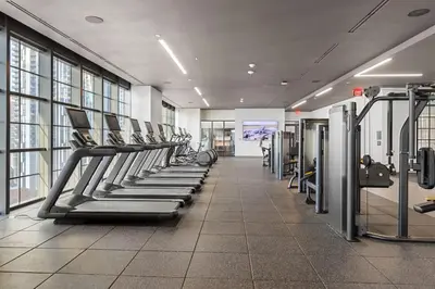 a gym with a row of treadmills and machines at 4905 Corner Penthouse with Sunset Views a Pool and Gym in Downtown Miami in Miami