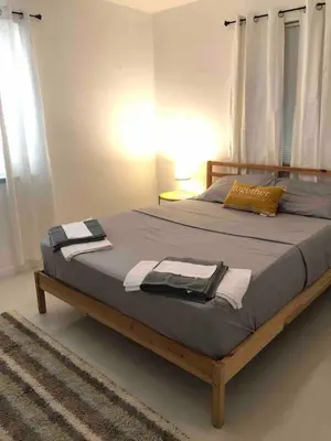 a bed with a wooden frame in a bedroom at Florida Cozy Home!!! in Hallandale Beach