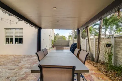 an outdoor dining room with a table and chairs at Great for Gatherings! Sleek and Relaxing Hialeah Gem in Hialeah