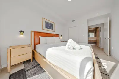 a bedroom with a large bed with white sheets at Spacious & Elegant 1BD Apt in Miami in Miami
